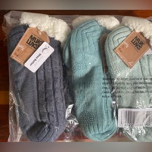 Brand new Muk Luks socks with grippers on feet, new with tags